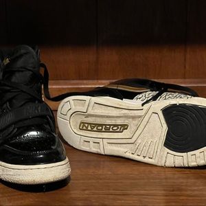 The are a pair of size 7 youth Jordan high top sneakers.
